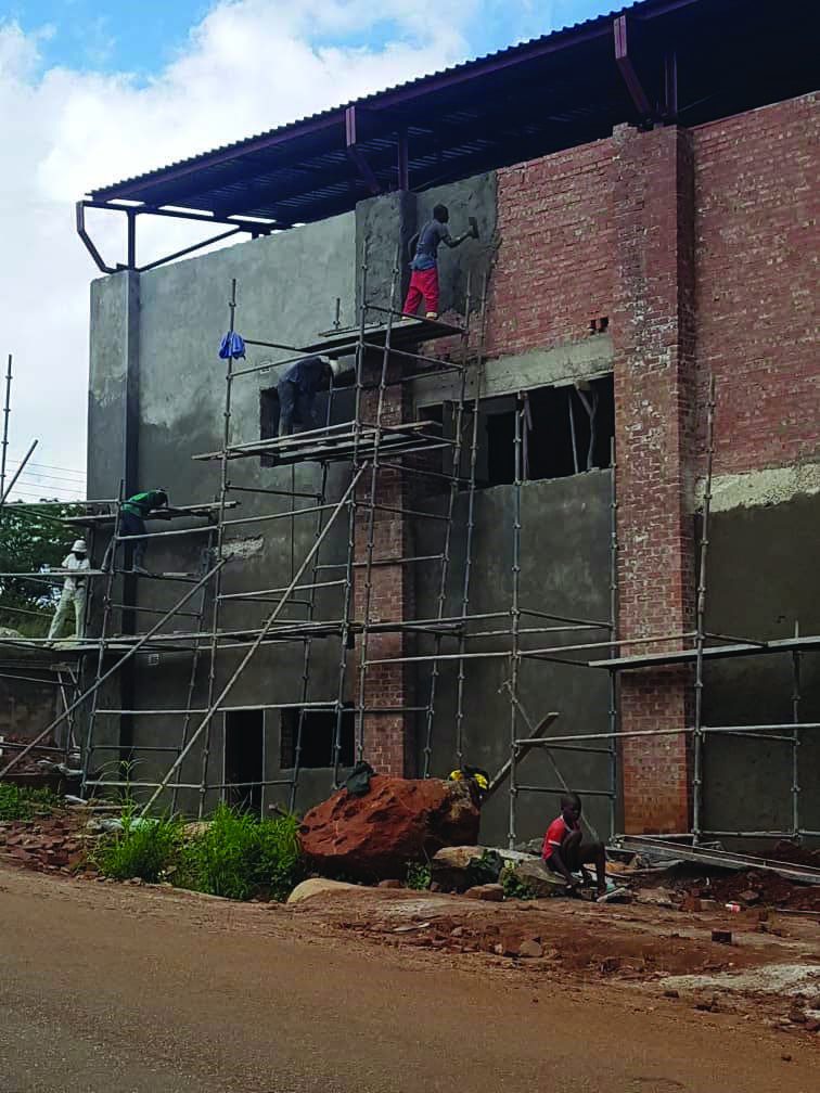 Workers plastering the Chishawasha Shopping Complex facade