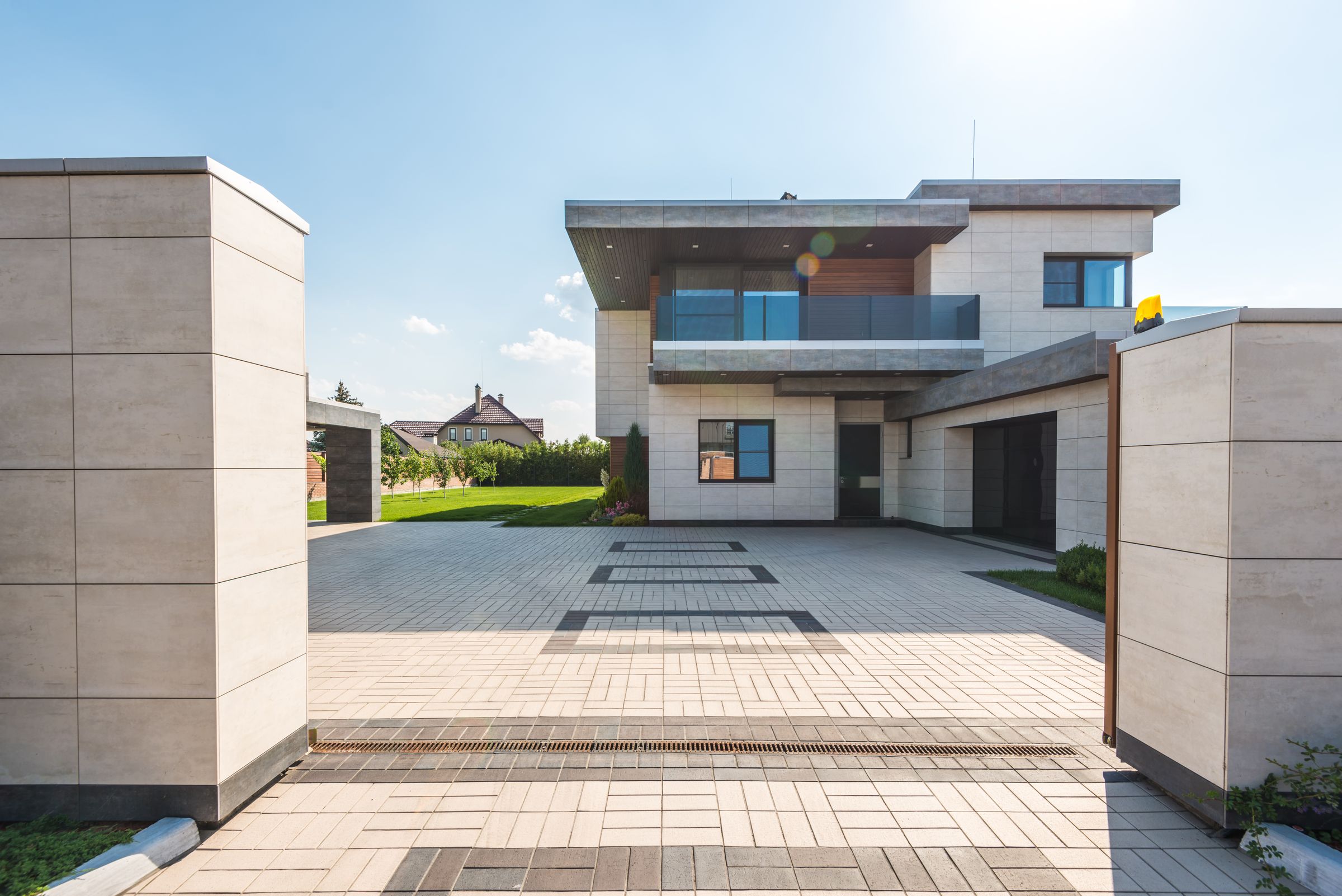 Contemporary two-storey home with stone finishes, broad windows and landscaped grounds
